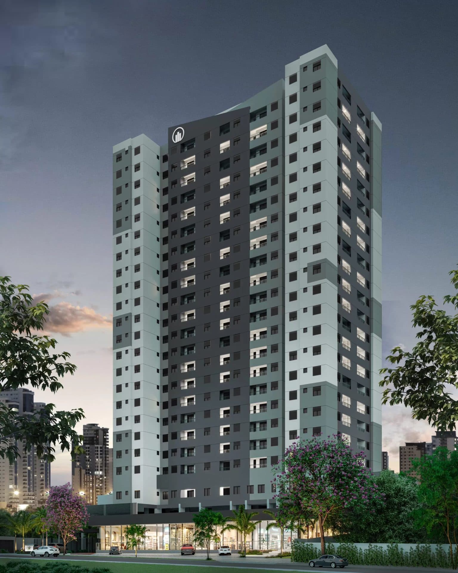 Vista externa noturna da torre do edifício residencial com iluminação nas janelas.