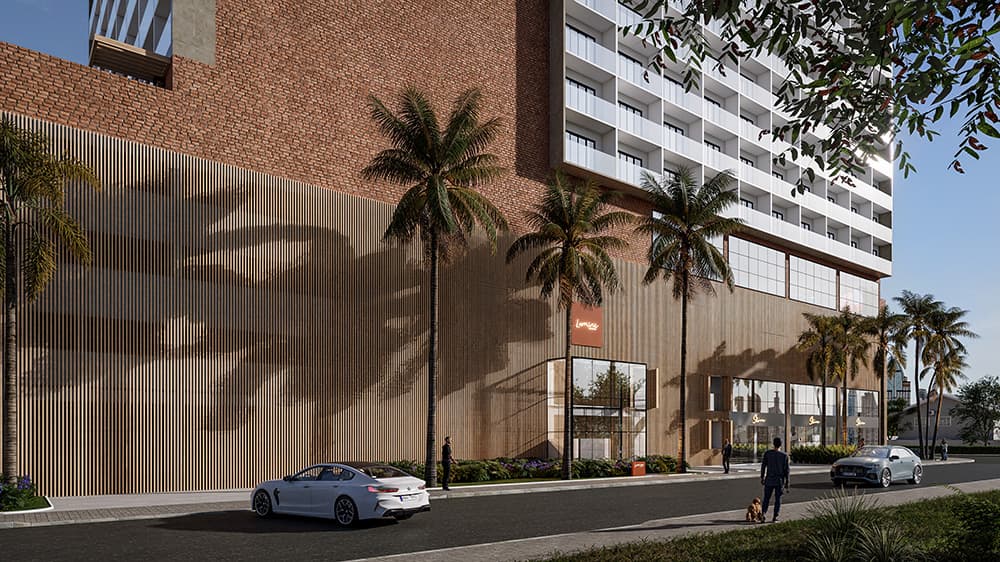 Fachada lateral de edifício com revestimento em tijolinhos e painéis amadeirados, térreo com lojas e paisagismo.
