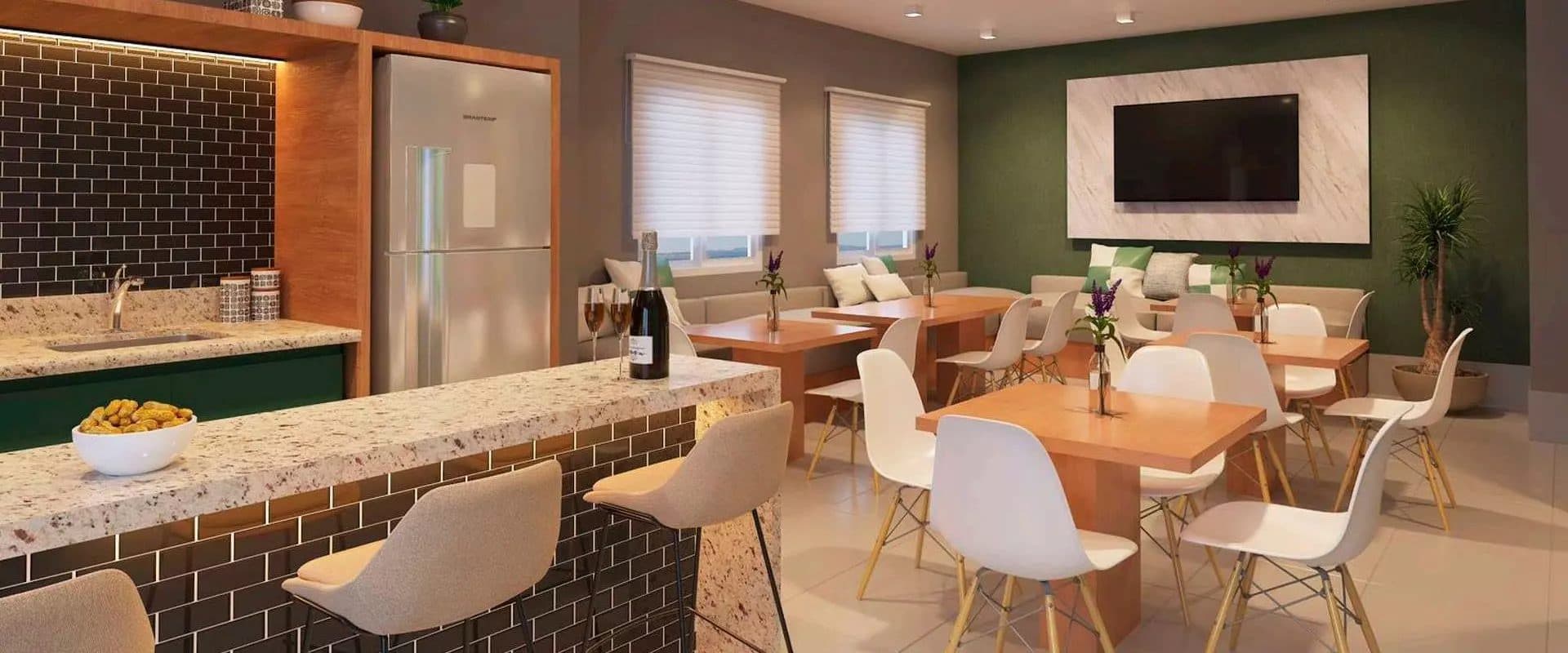 Espaço gourmet com bancada em granito, banquetas, mesas de jantar e TV.