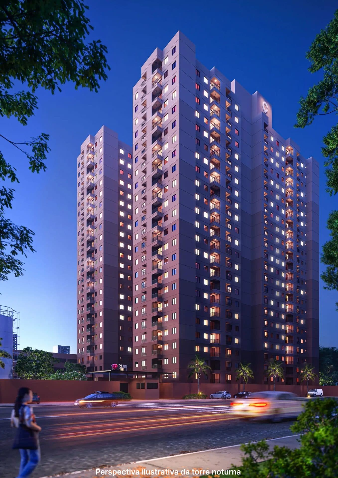 Fachada do edifício residencial em tons terrosos durante a noite com iluminação.